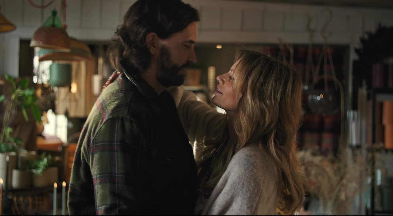 A man and woman embrace.