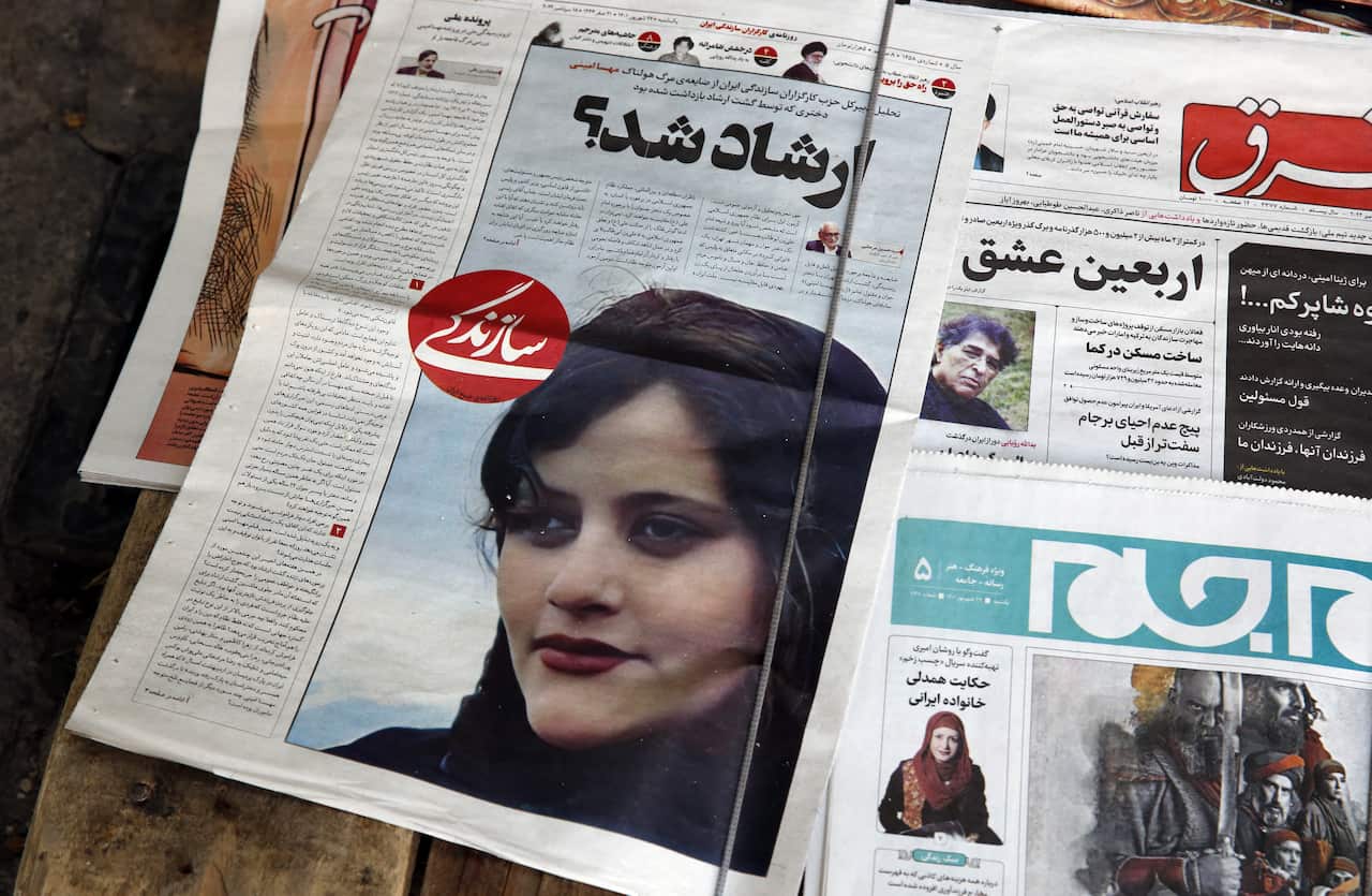 A newspaper showing Mahsa Amini who died in September last year.