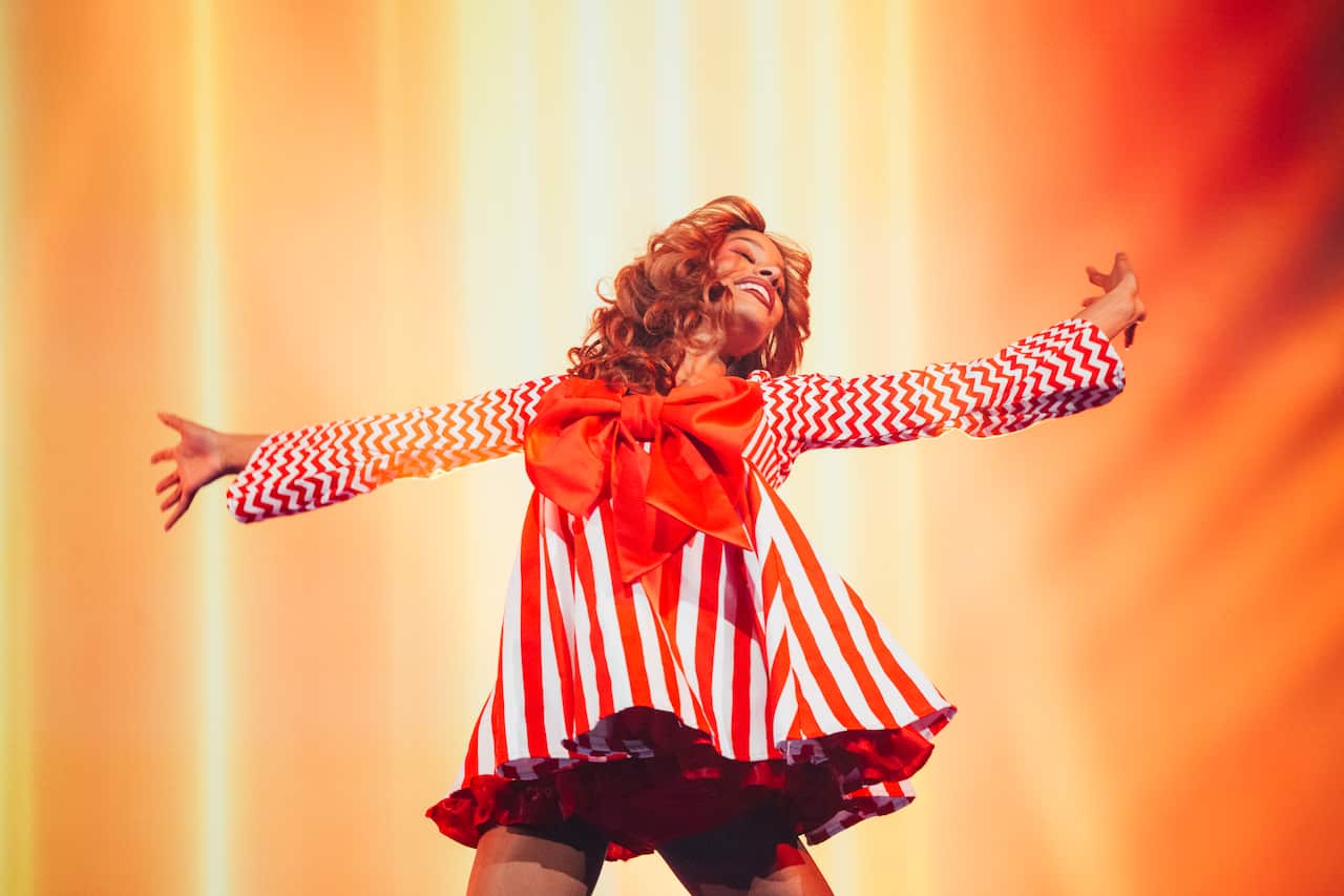 Jenaya Okpalanze, member of Surely Shirley, partner of Go-Jo and back-up dancer, displaying her costume change with open arms during the Eurovision Song Contest performance of Milkshake Man.