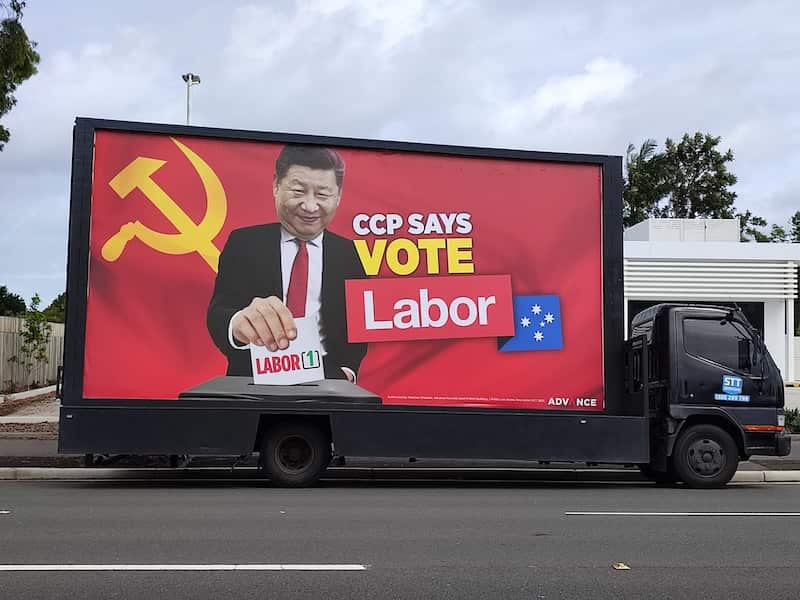 A truck featuring a billboard with the words "CCP says vote Labor". 