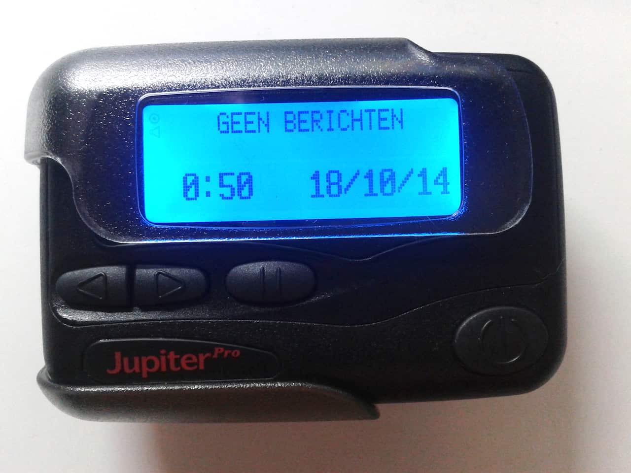 A close-up picture of a pager illuminated with blue light on the screen. 