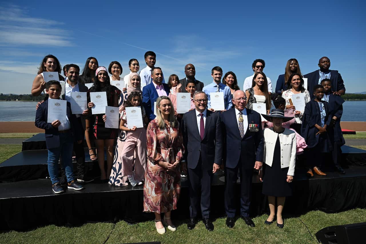 Prime Minister Anthony Albanese and Governor General David Hurley take part in a group photo with 23 of Australia's newest citizens in Canberra. 