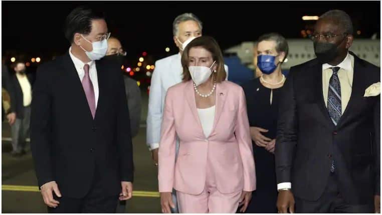 US House Speaker Nancy Pelosi, (centre), walks with Taiwan's Foreign Minister Joseph Wu, (left), as she arrives in Taipei, Taiwan on Tuesday, 2 August, 2022. Credit: AP
