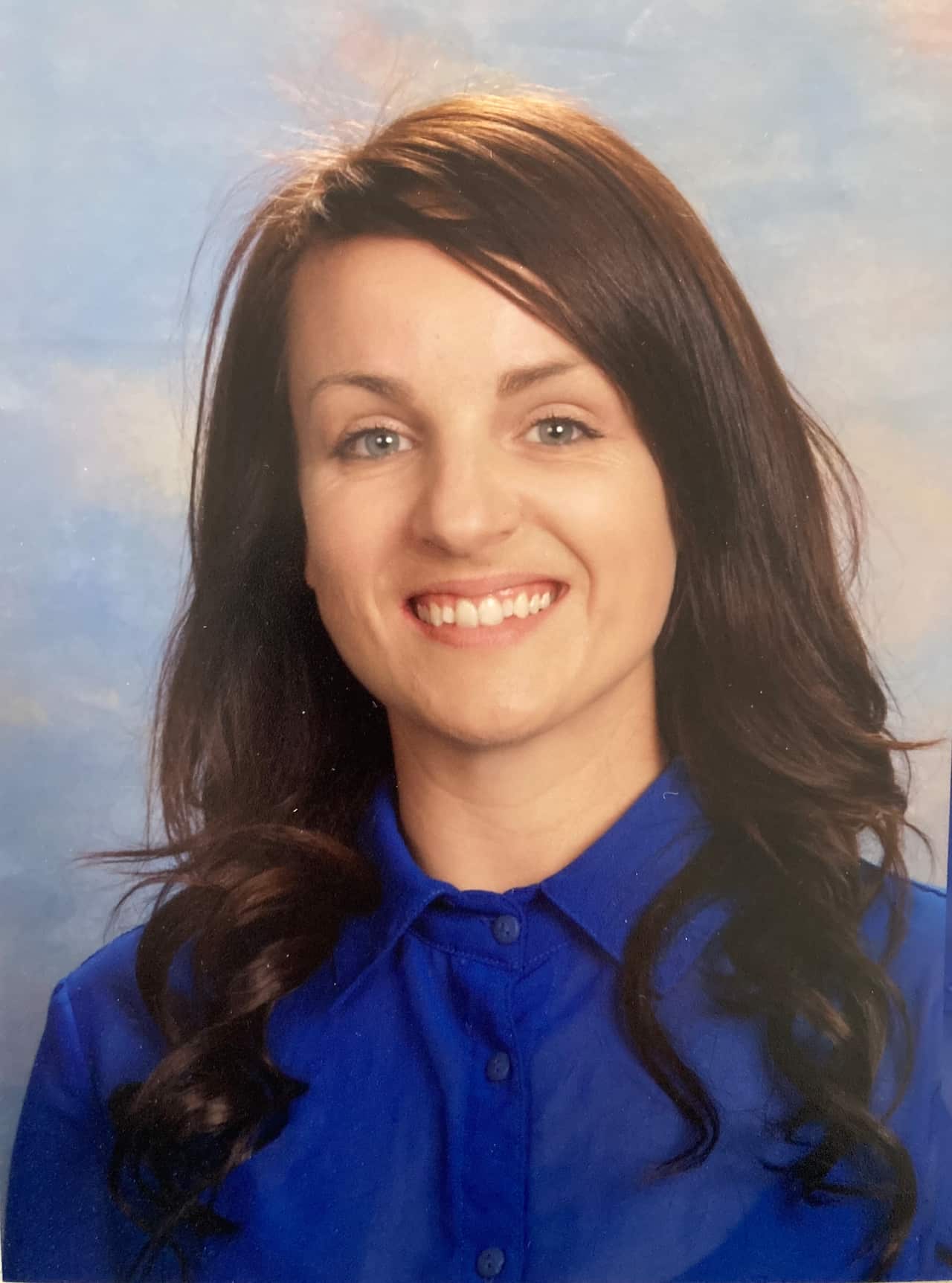 A professional headshot of a woman