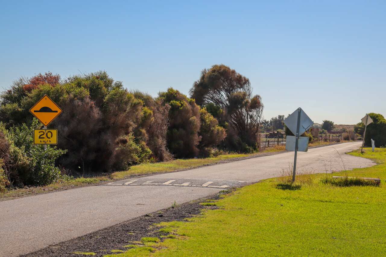 Road with speed hump sign. This type of speed hump is usually confused with a zebra crossing