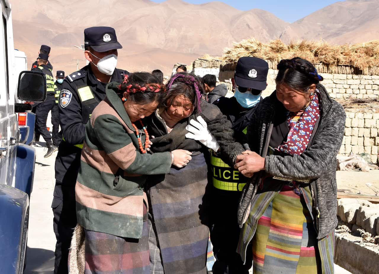 Injured women being assisted by emergency services