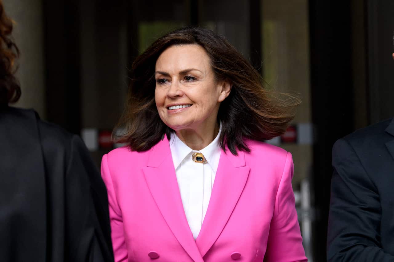 A woman in the pink jacket