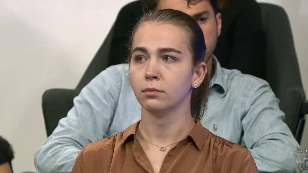 A woman seated in an audience.