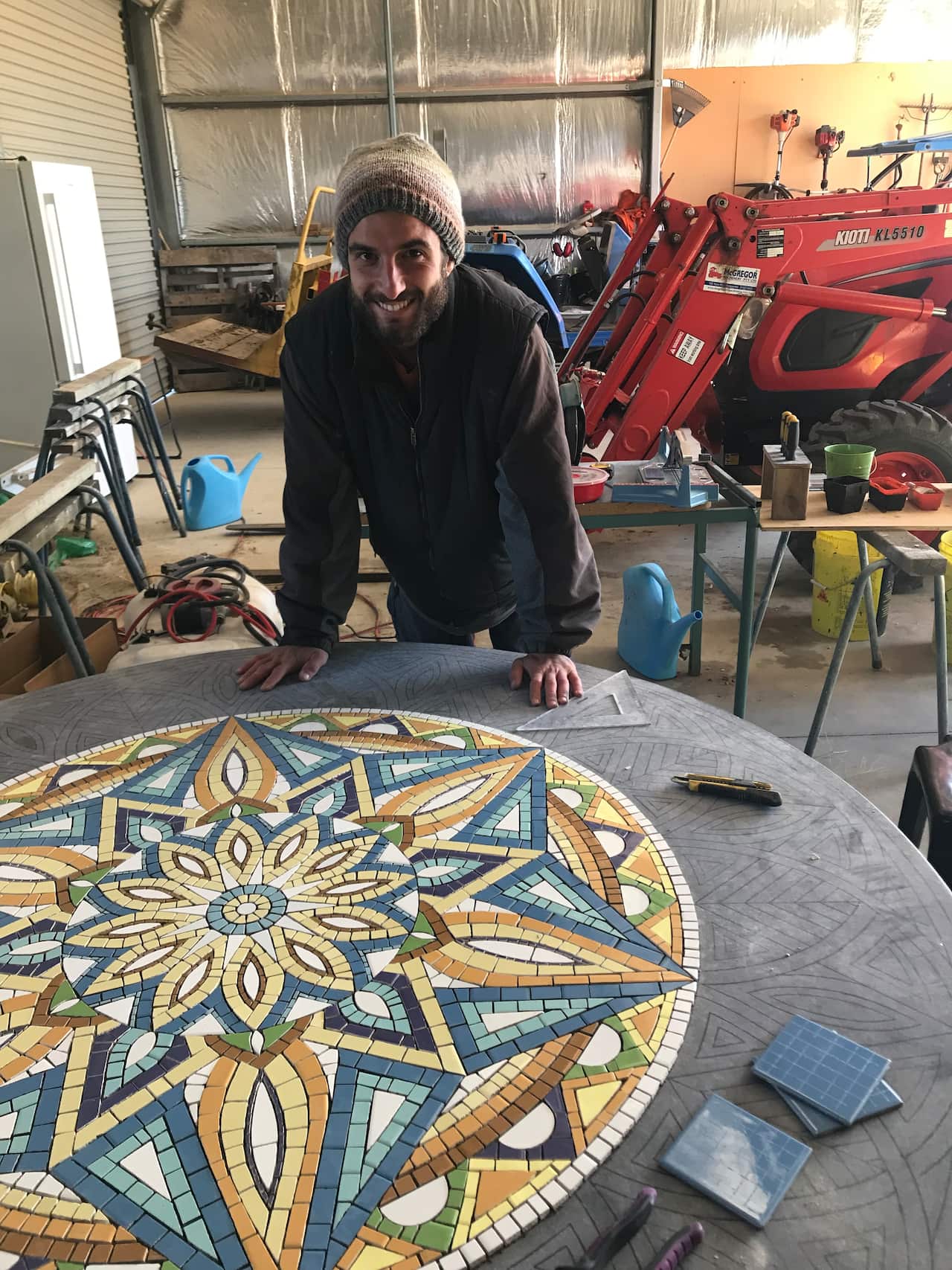 Umberto Pepe working on a mosaic table.