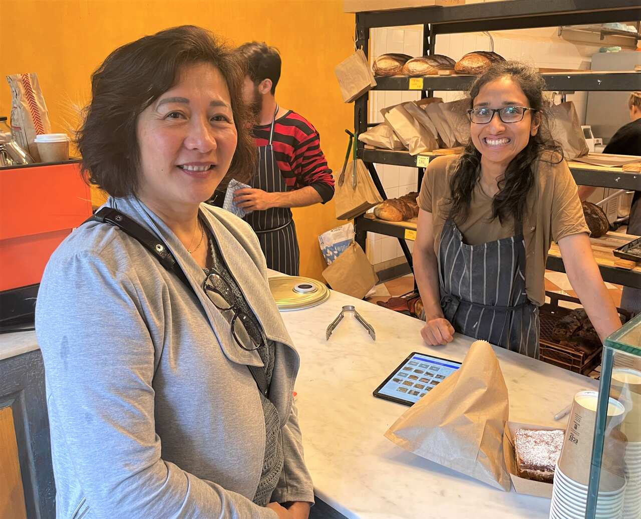 Anu Haran with a female customer at her Sydney bakery