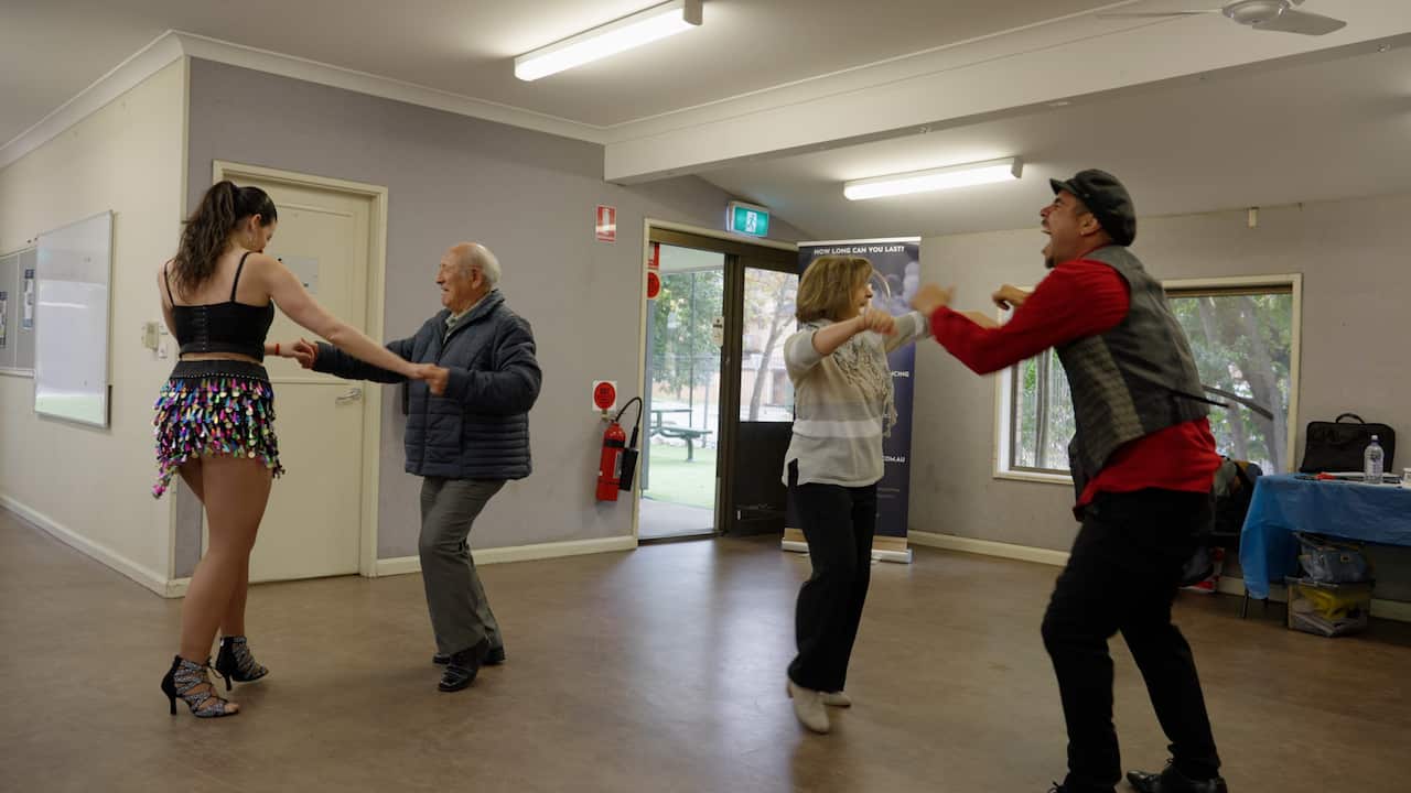 Mario and another member of the Spanish club dancing with salsa dancers.