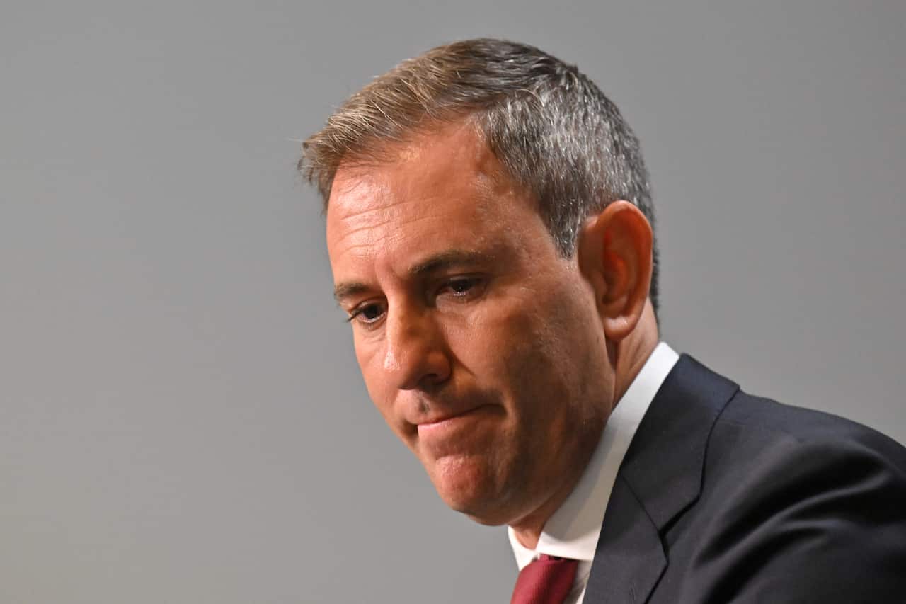 A man in a suit and tie at a press conference.