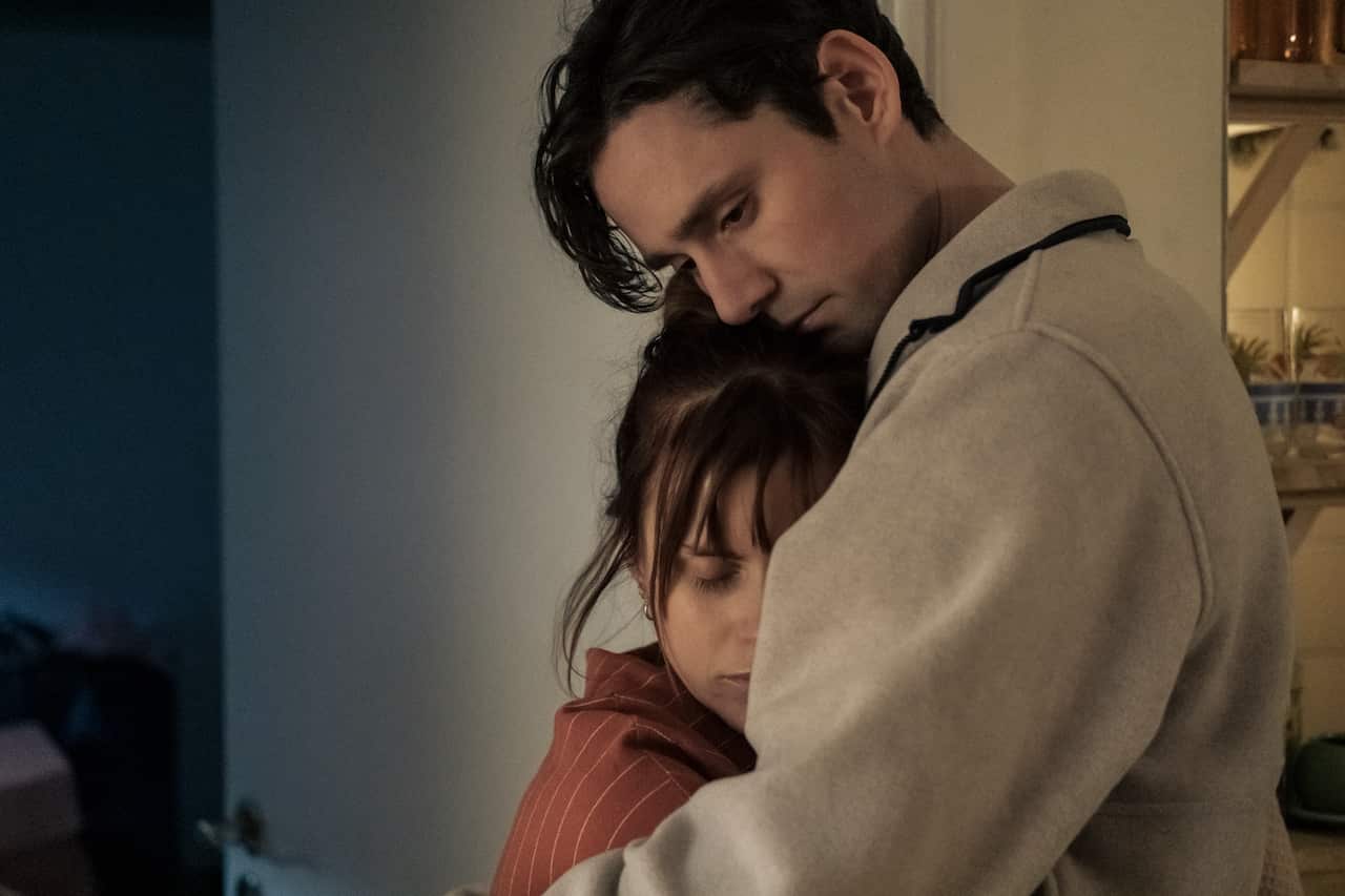 A standing man and woman embrace lovingly.jpeg