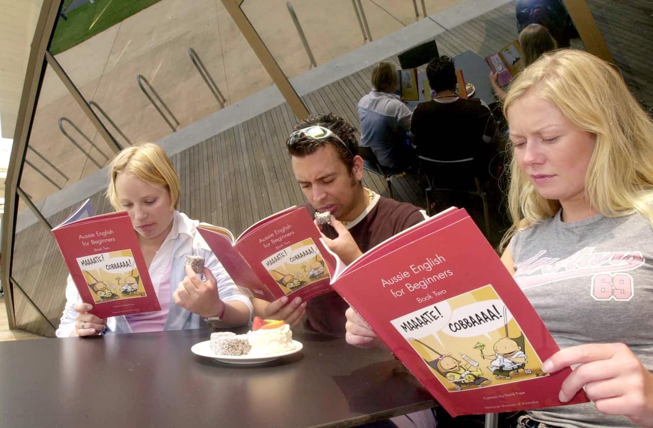 Three people eating and reading books 