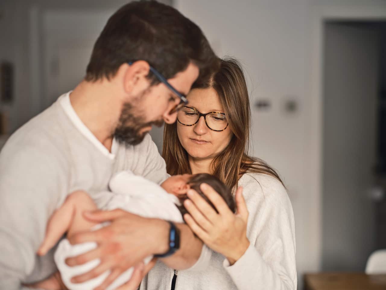 A couple holding a newborn.
