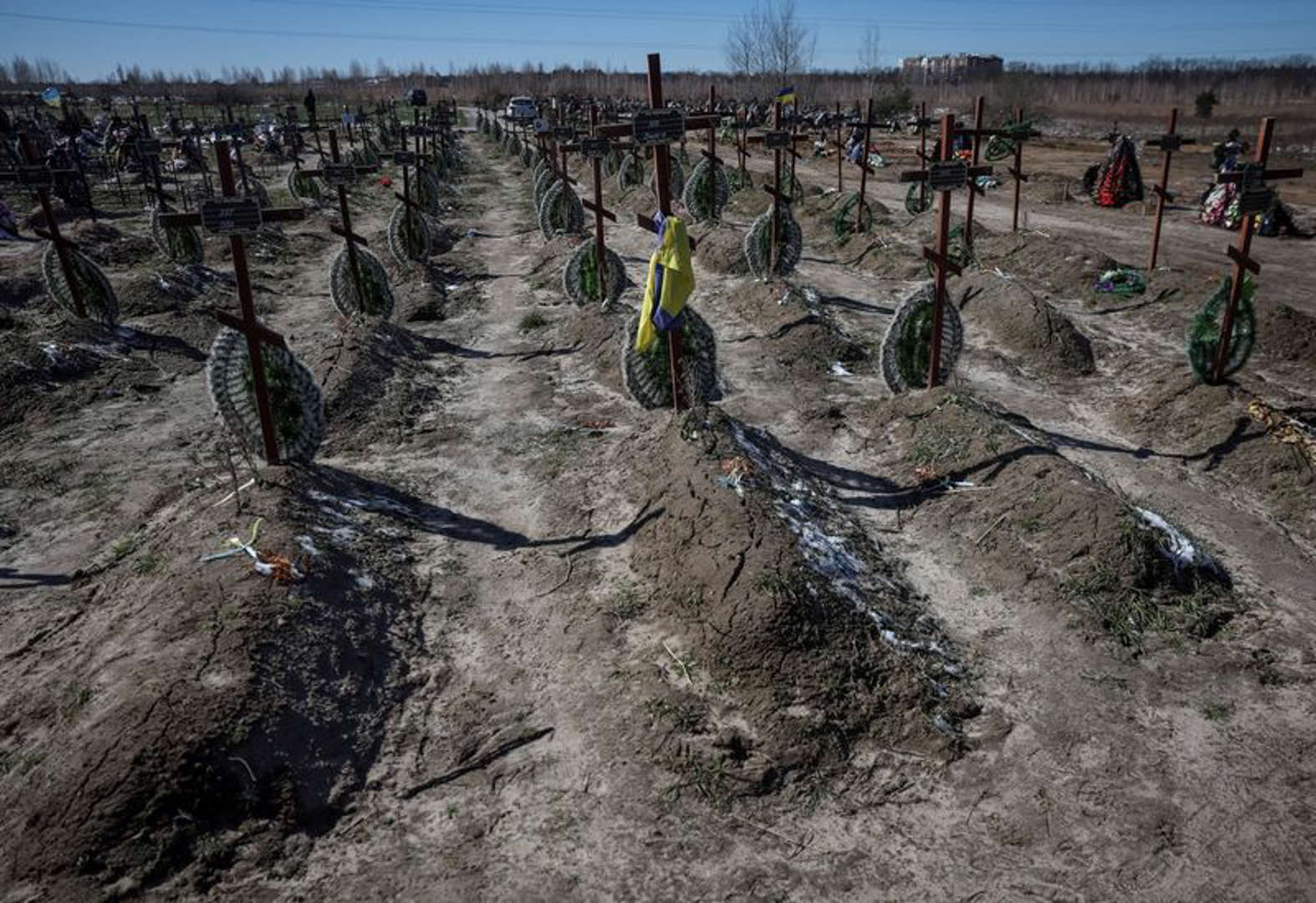 Graves of unidentified people killed by Russian soldiers during occupation of the Bucha town, are seen at the town's cemetery outside Kyiv.jfif