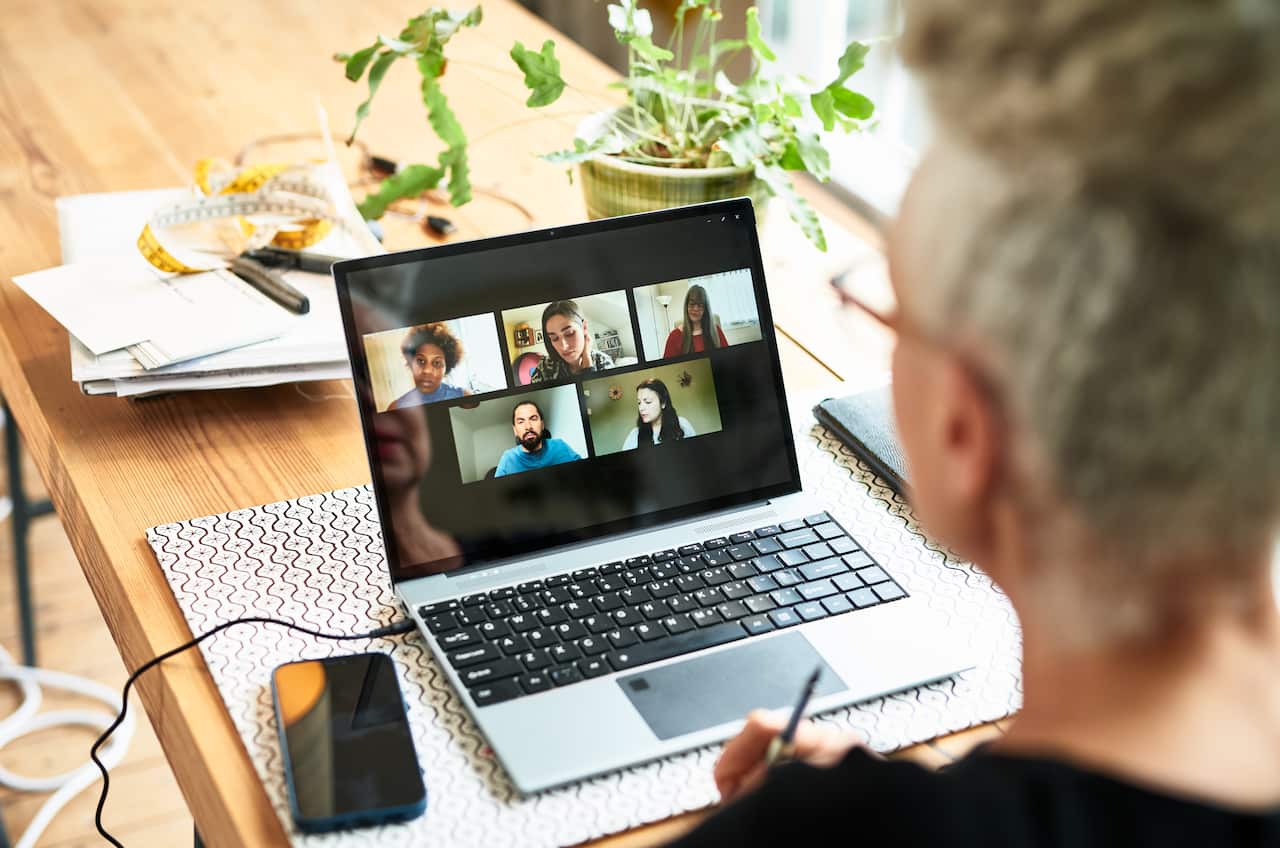 Woman using laptop for team meeting video conference
