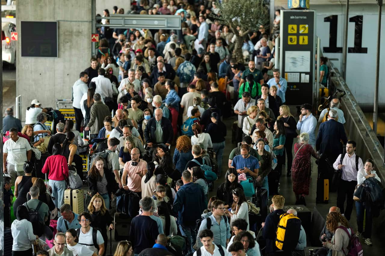 A large crowd of people at an airport.