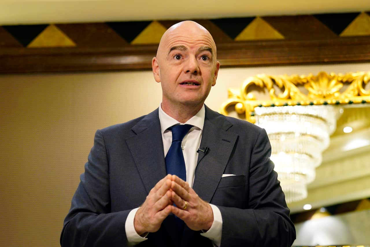 Man standing wearing suit.