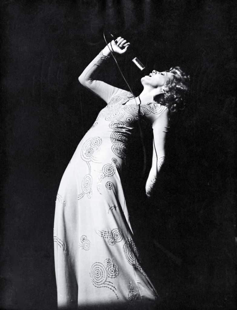 Italian singer and actress Ornella Vanoni back-bending during a performance. 1970s.