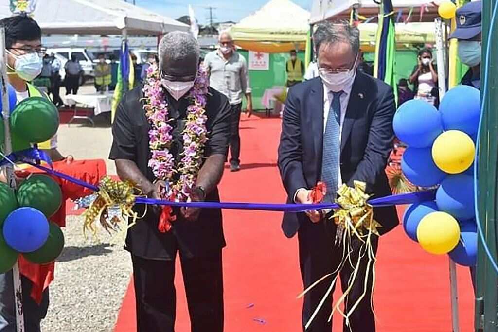 China's ambassador to the Solomon Islands Li Ming (right), and Solomons Prime Minister Manasseh Sogavare cutting a ribbon during the opening ceremony of a China-funded national stadium complex in Honiara on 22 April.