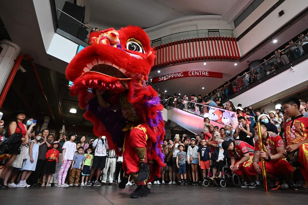 Members of the Jin Wu Koon dance troupe perform a roving lion dance at Paddy’s Markets in Sydney