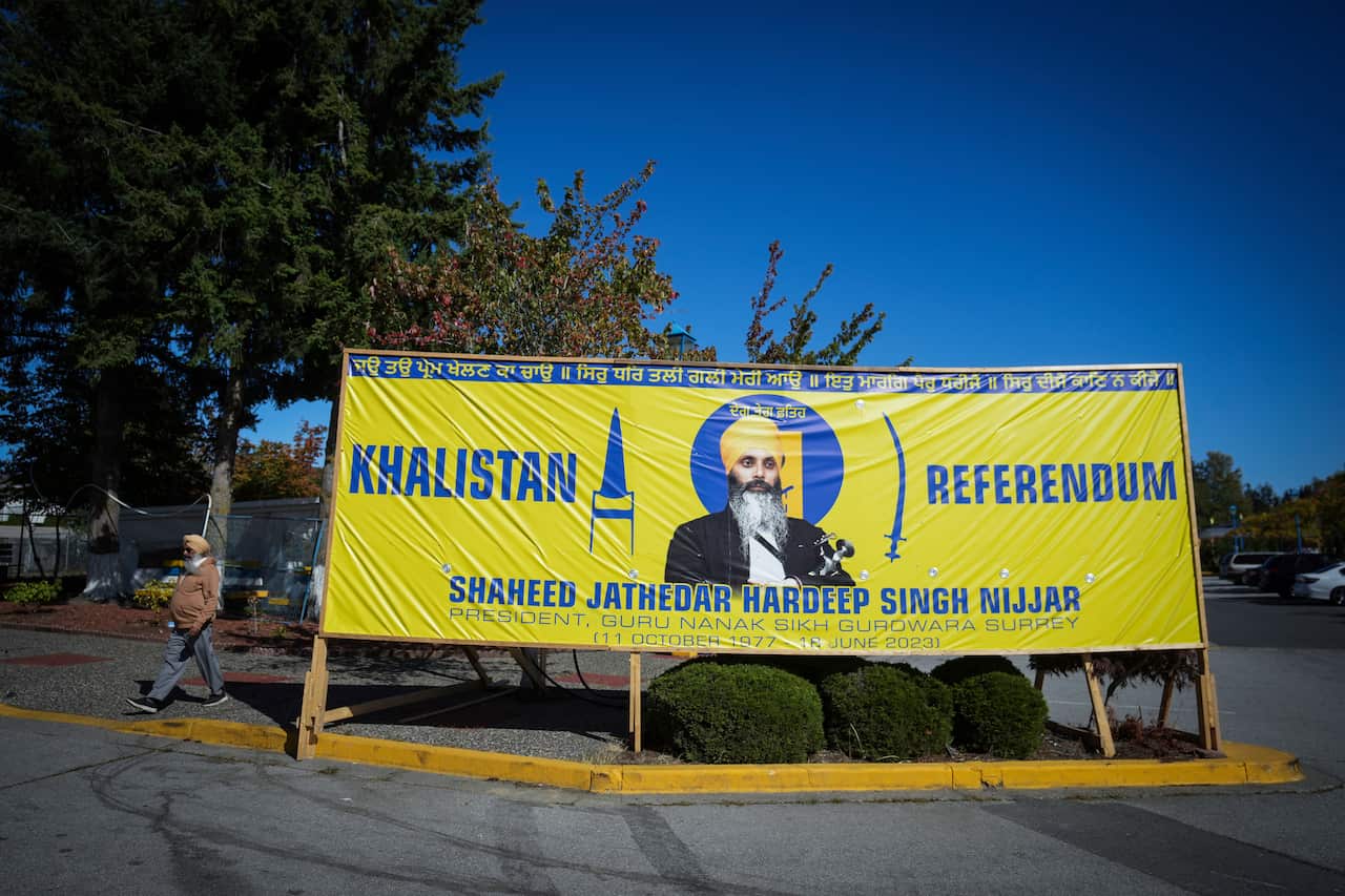 A yellow banner with blue writing labelled Khalistan Referendum, with leader Hardeep Singh Nijjar centre of poster