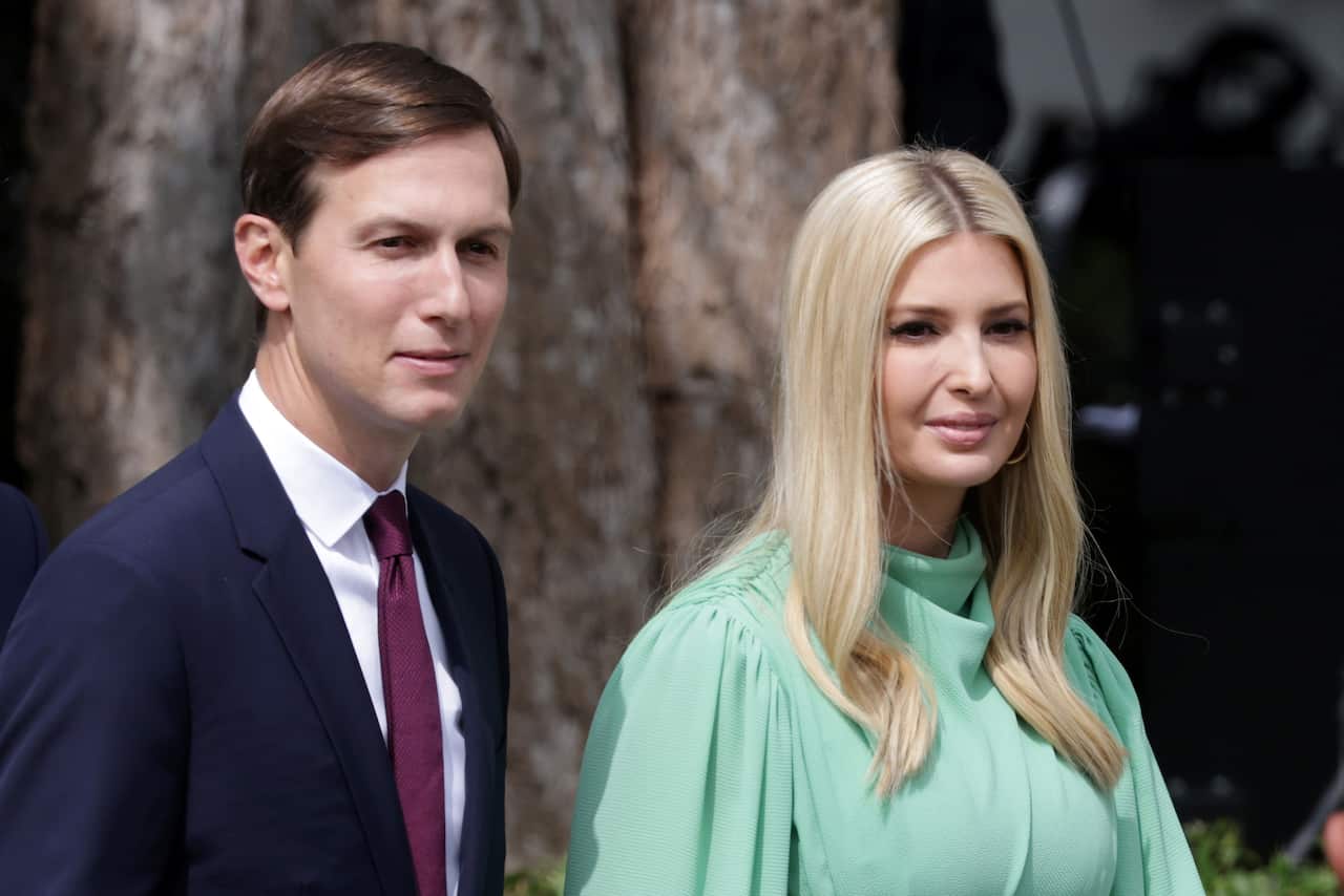 On the left is Jared Kushner who wears a navy suit and burgundy tie with a blank face, and alongside him is his wife Ivanka whose hair is mid-length, blonde and has a small smile.
