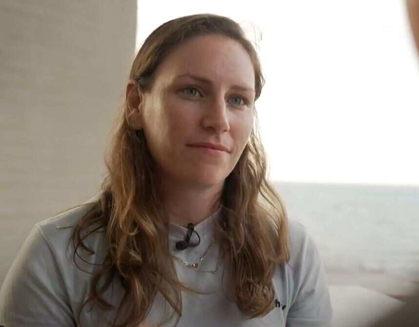 A woman looking at a camera.