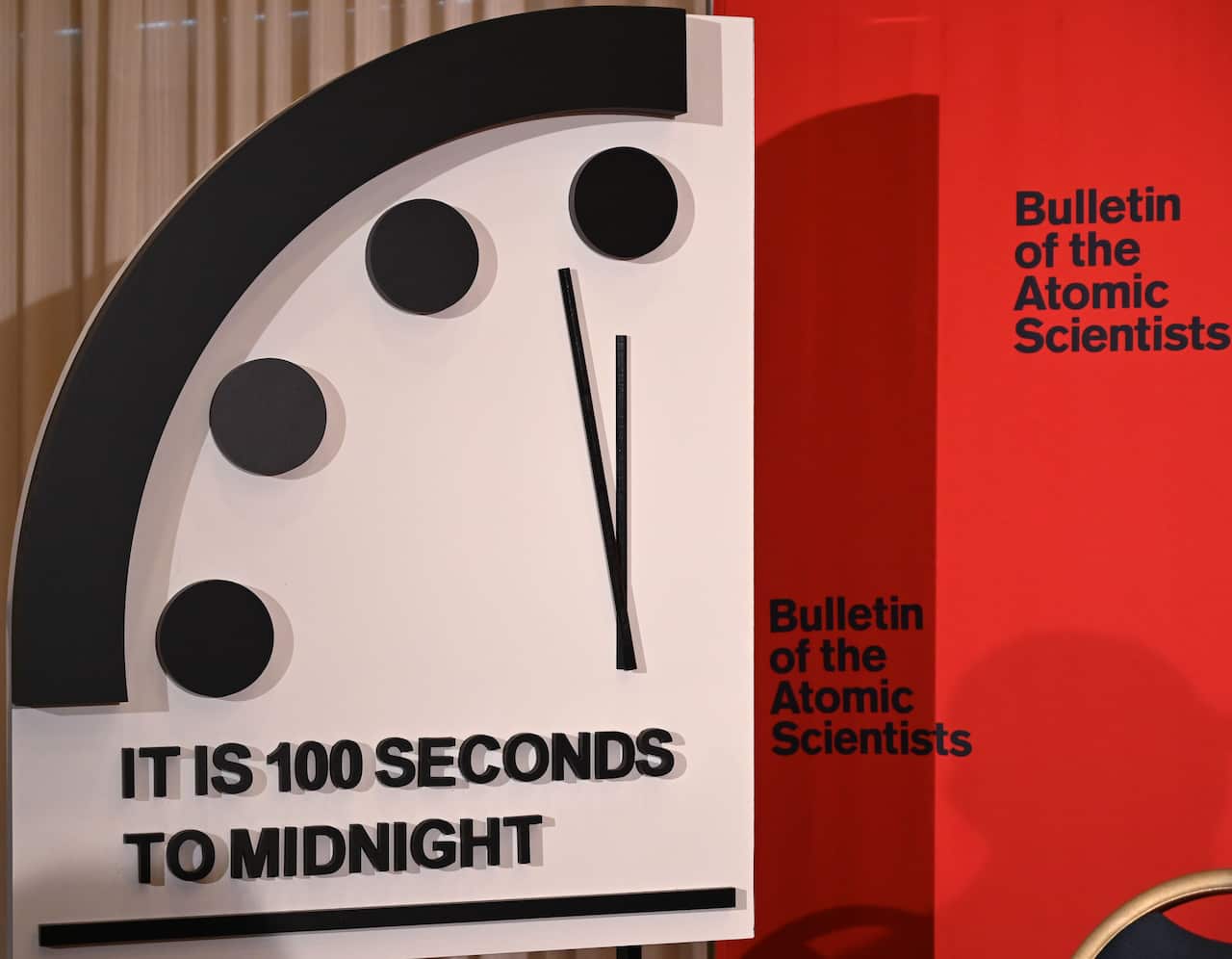 A display that shows part of a clock with the text: "It is 100 seconds to midnight".