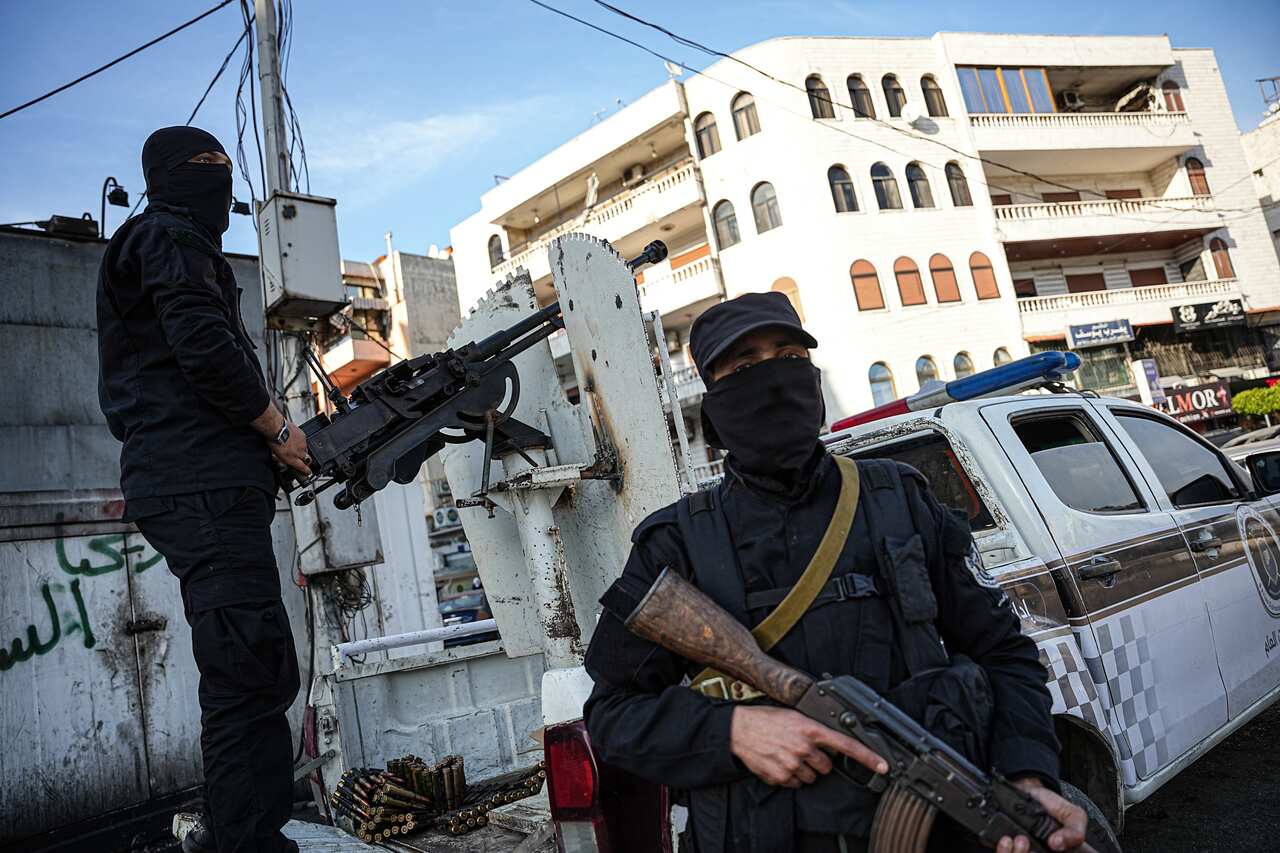 Two soldiers with face masks and rifles