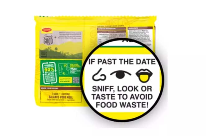 the back of a yellow packet of noodles. The words: "If past the date sniff, look or taste to avoid food waste!" are magnified as are line drawings of a nose, and eye and a tongue.