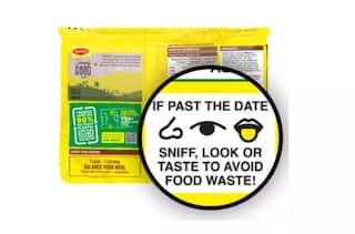 the back of a yellow packet of noodles. The words: "If past the date sniff, look or taste to avoid food waste!" are magnified as are line drawings of a nose, and eye and a tongue.