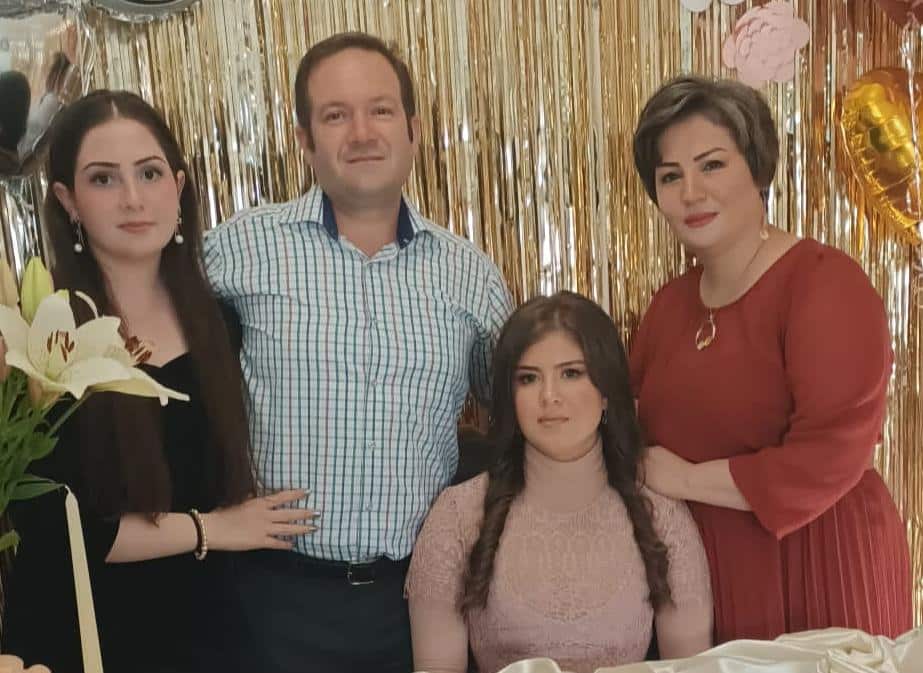 Helia Diba (left) and her father, sister and mother posing for a photograph