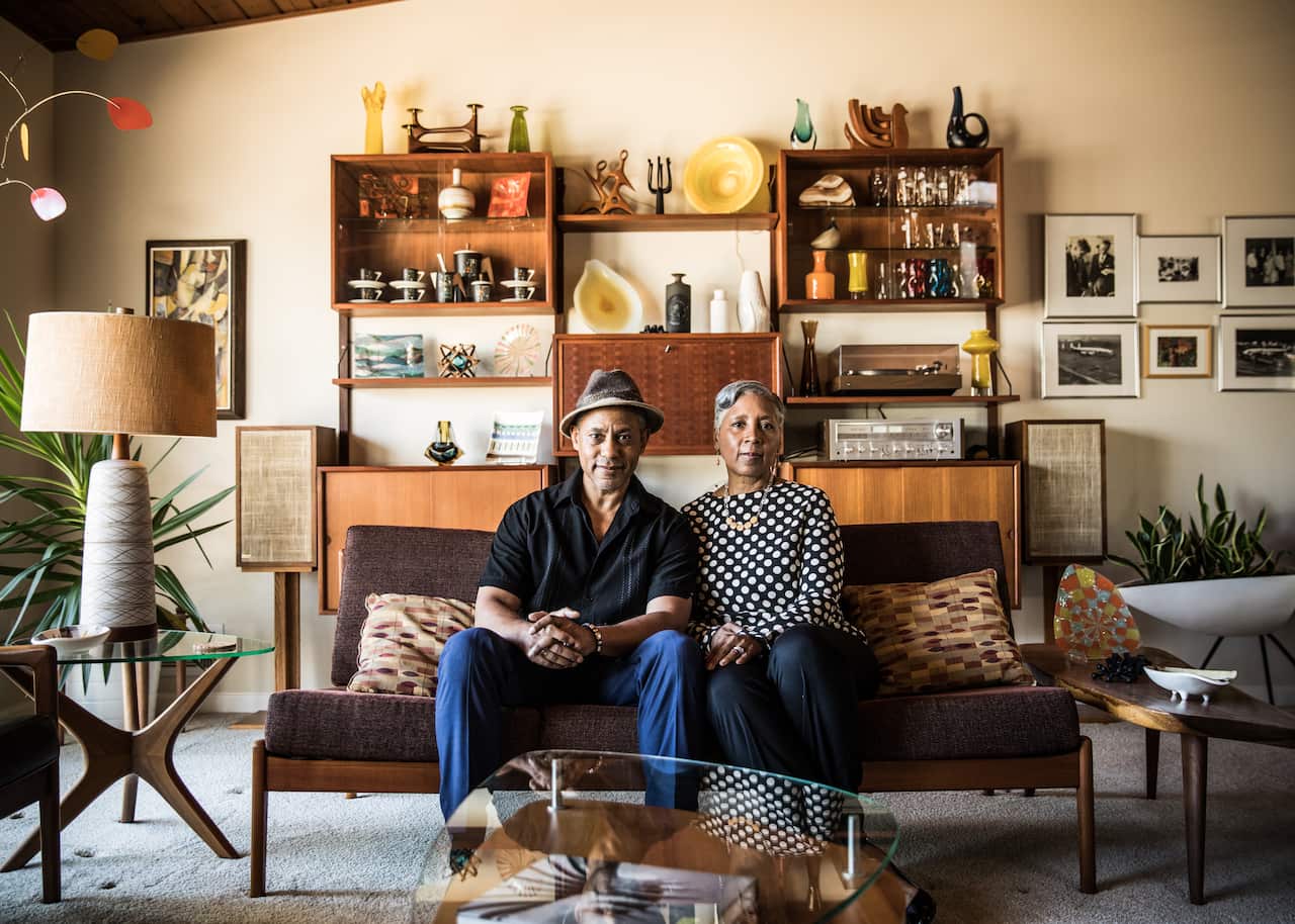 Portrait of senior couple sitting on couch at home
