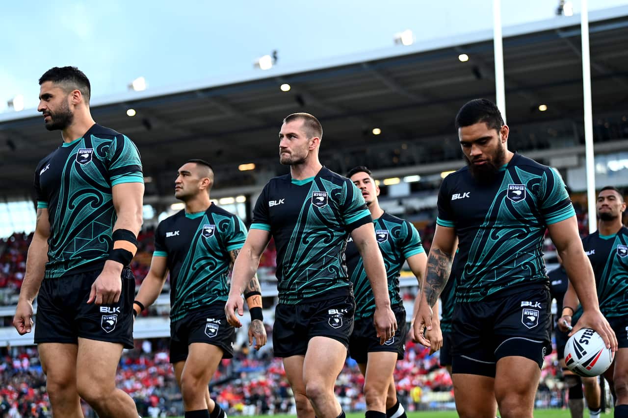 Kiwi players walk onto the field. 