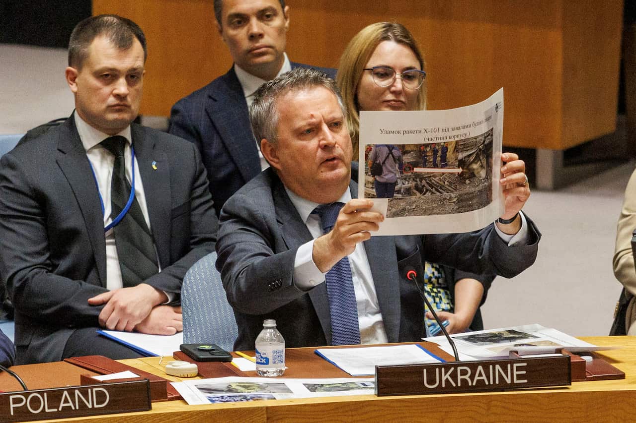 Ukraine's Ambassador Sergiy Kyslytsya shows a slide of pictures showing the recent attacks on Ukraine by Russia during a UN Security Council meeting at the United Nations Headquarters in New York.