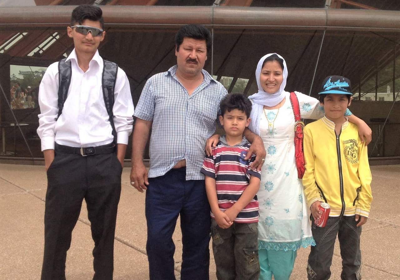 (left to right) Kumail Jaffry, a man a woman and two children pose for a photo outside 