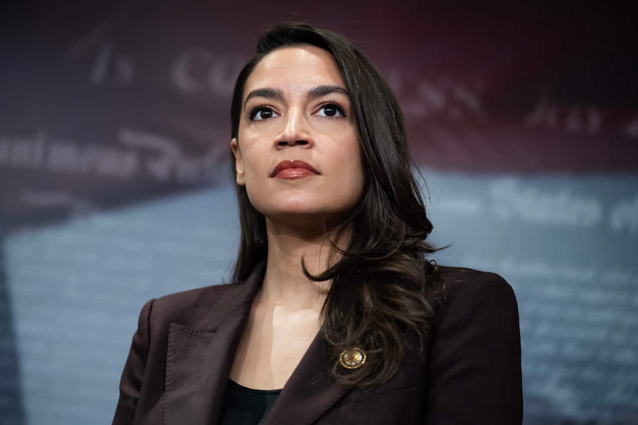 Alexandria Ocasio-Cortez in a brown suit