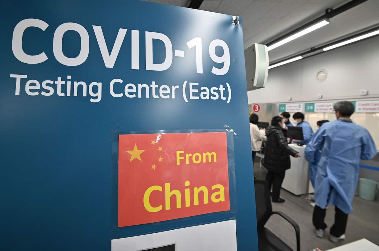 A sign at an airport reading 'COVID-19 testing centre - from China'