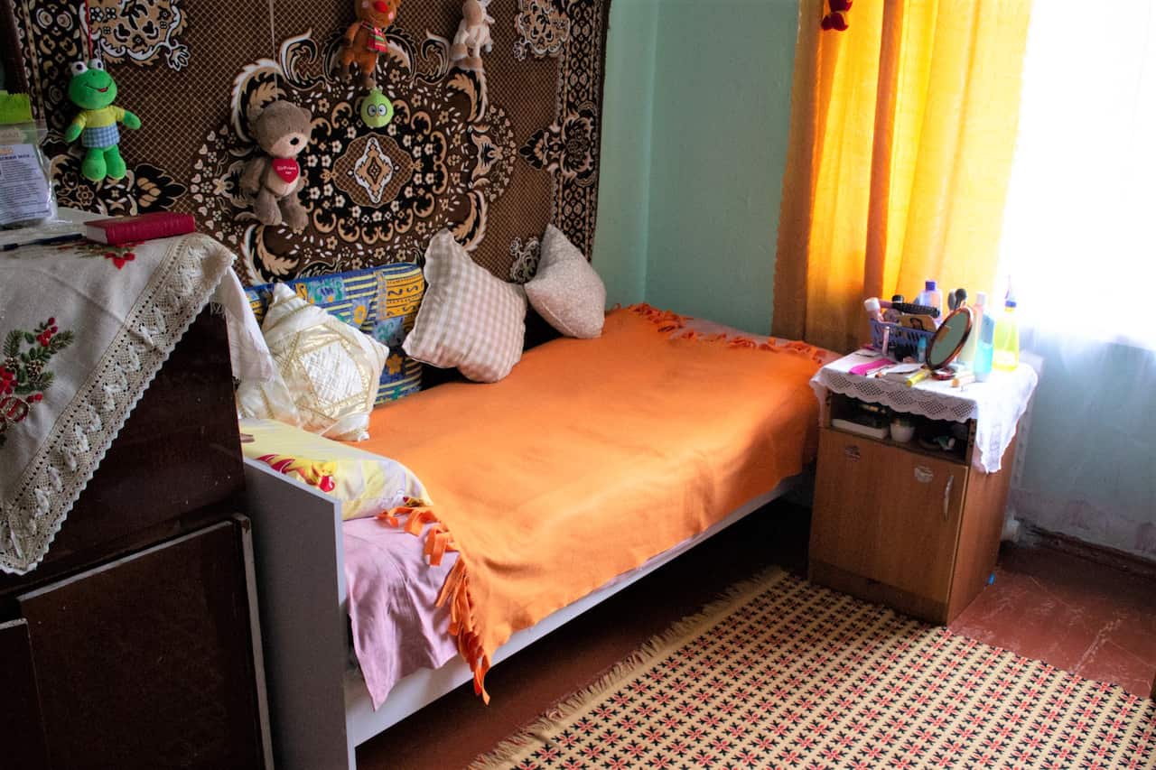 A Ukraine emergency housing bedroom furnished with donated funds.