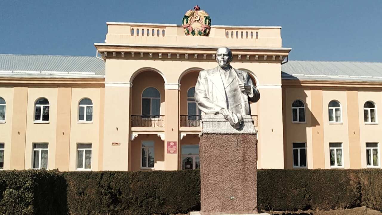 A bust of Vladimir Lenin in front of a Soviet-era building in Transnistria.