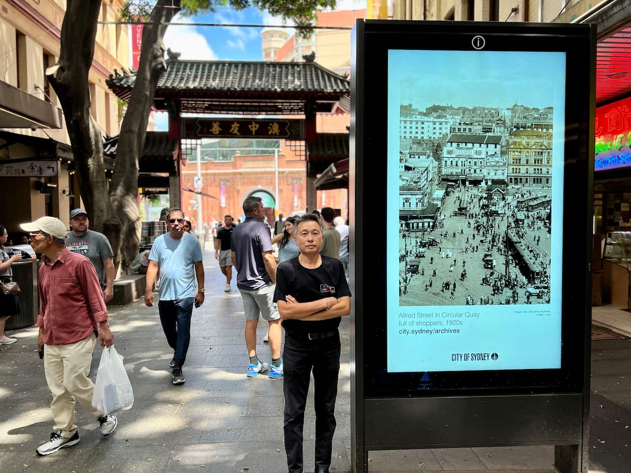 Peter Wong standing next to one of four advertising screens he wants removed from Sydney's Chinatown. 