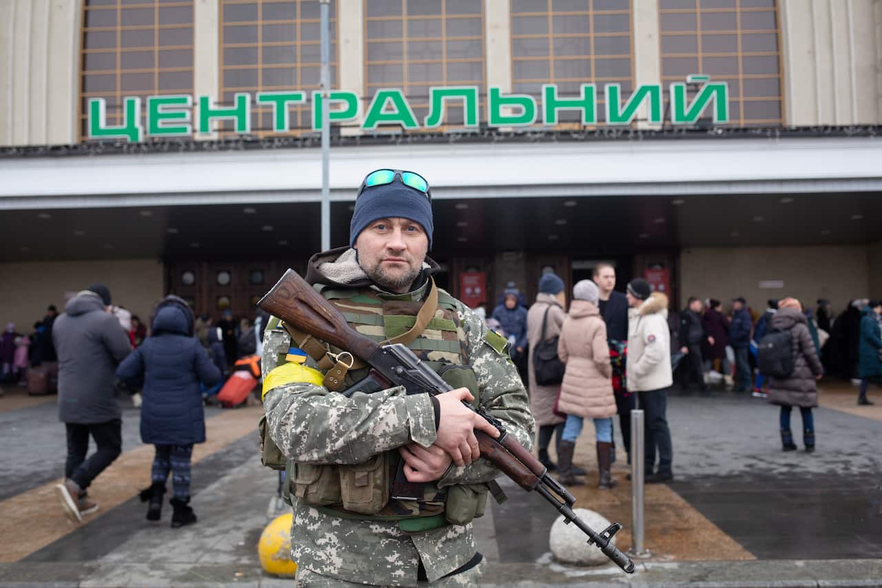 A Ukrainian serviceman stands guard outside the central railway station