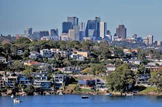 Sydney residential property seen from the water with the city skyline in the background.