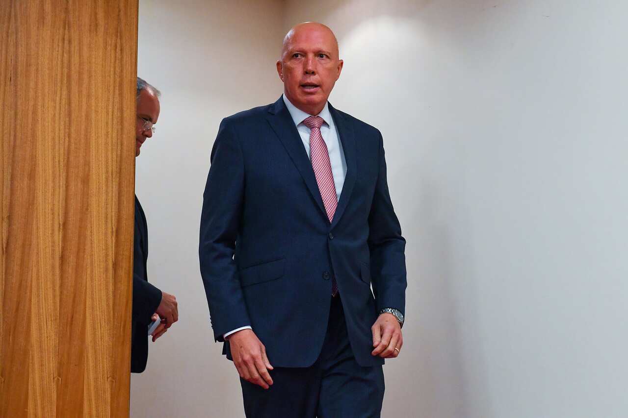 Peter Dutton enters the room for a press conference (AAP)