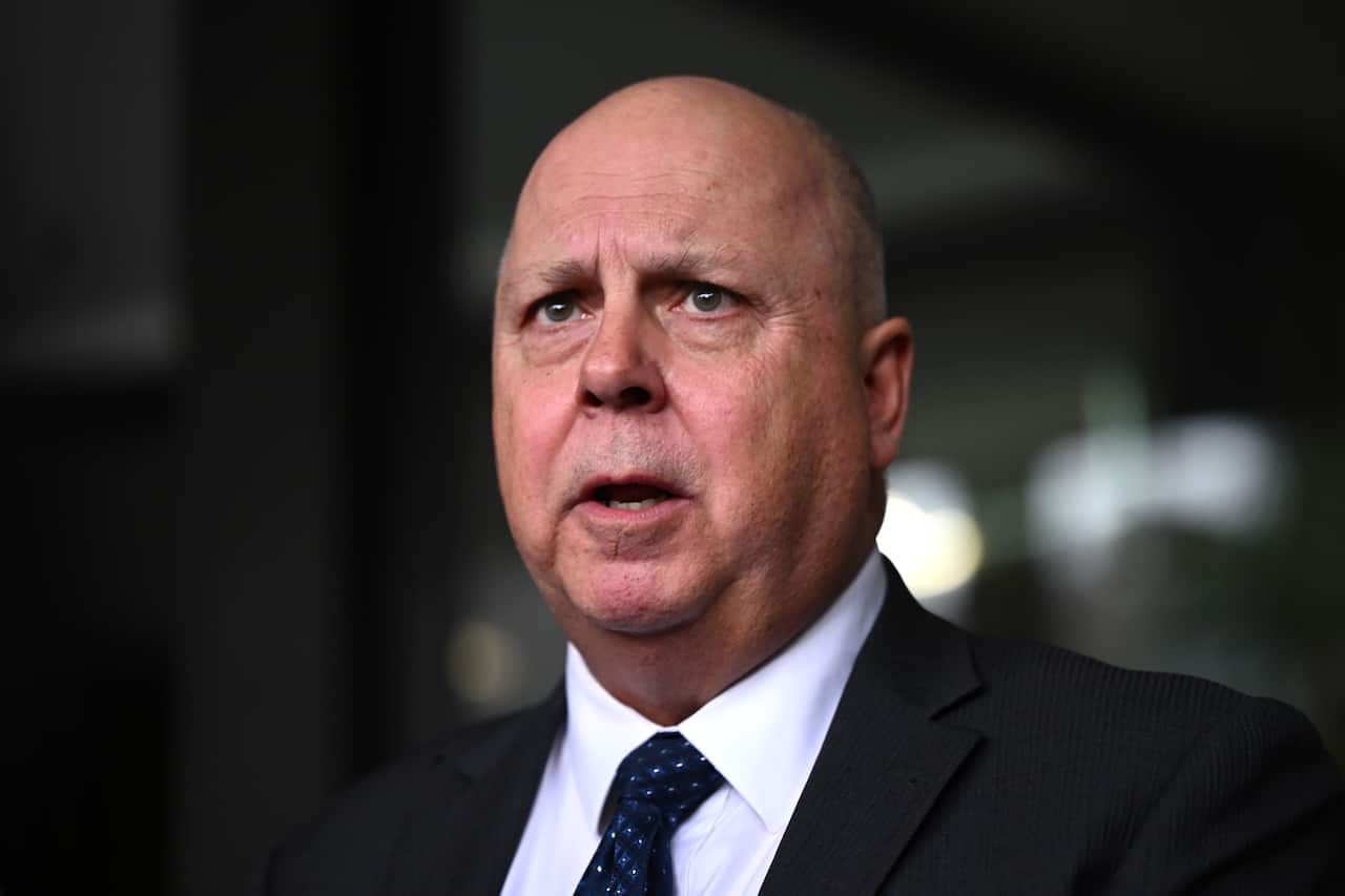 A man in a suit speaking.