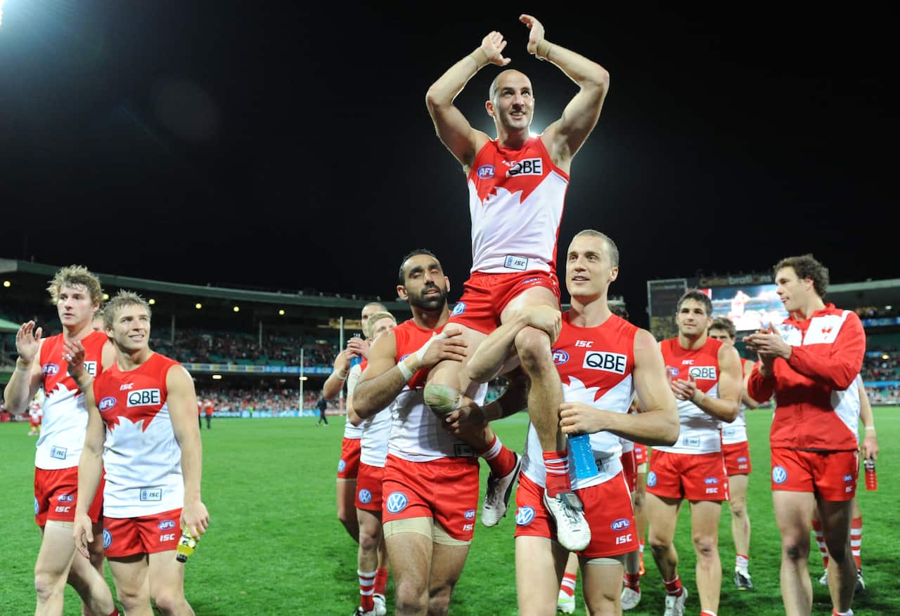Tadhg is carried on the shoulders of two teammates from the Sydney Cricket Ground