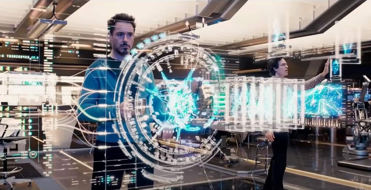 A man is thinking in front of a hologram. 