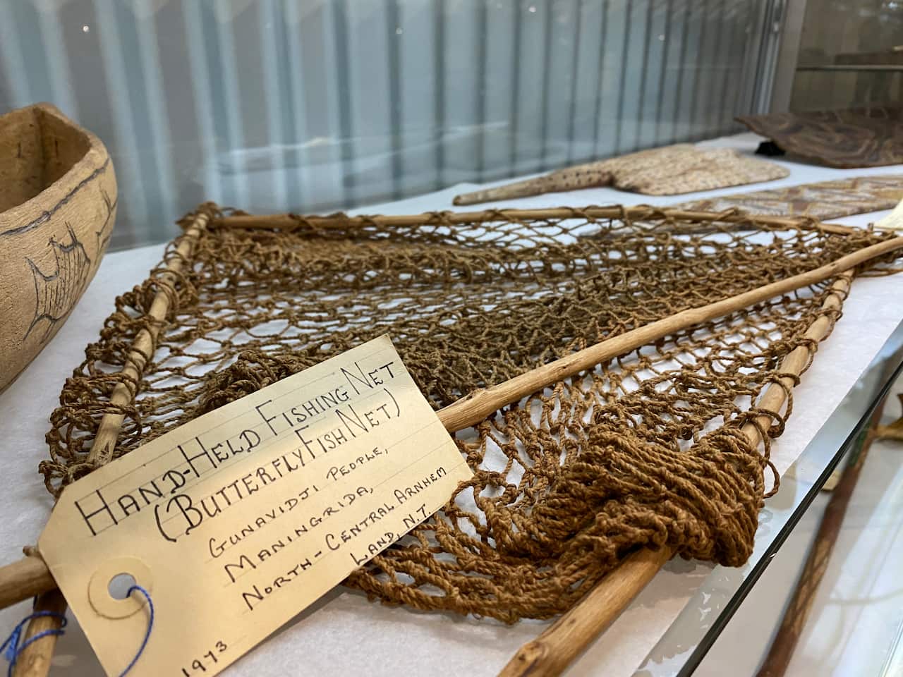 A fishing net edged with sticks.